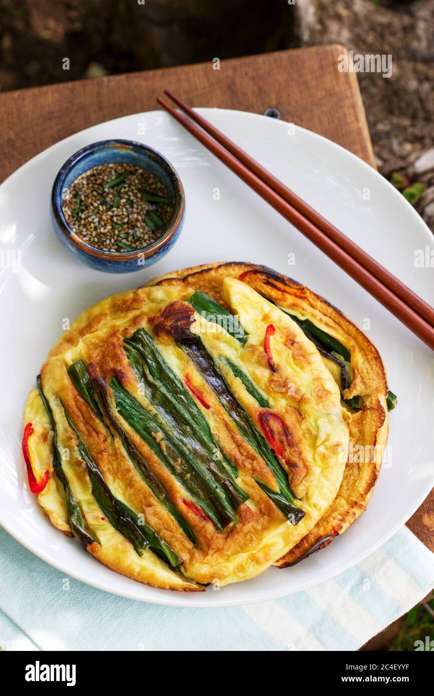 Traditional Korean fritters with green onions and chili, served with