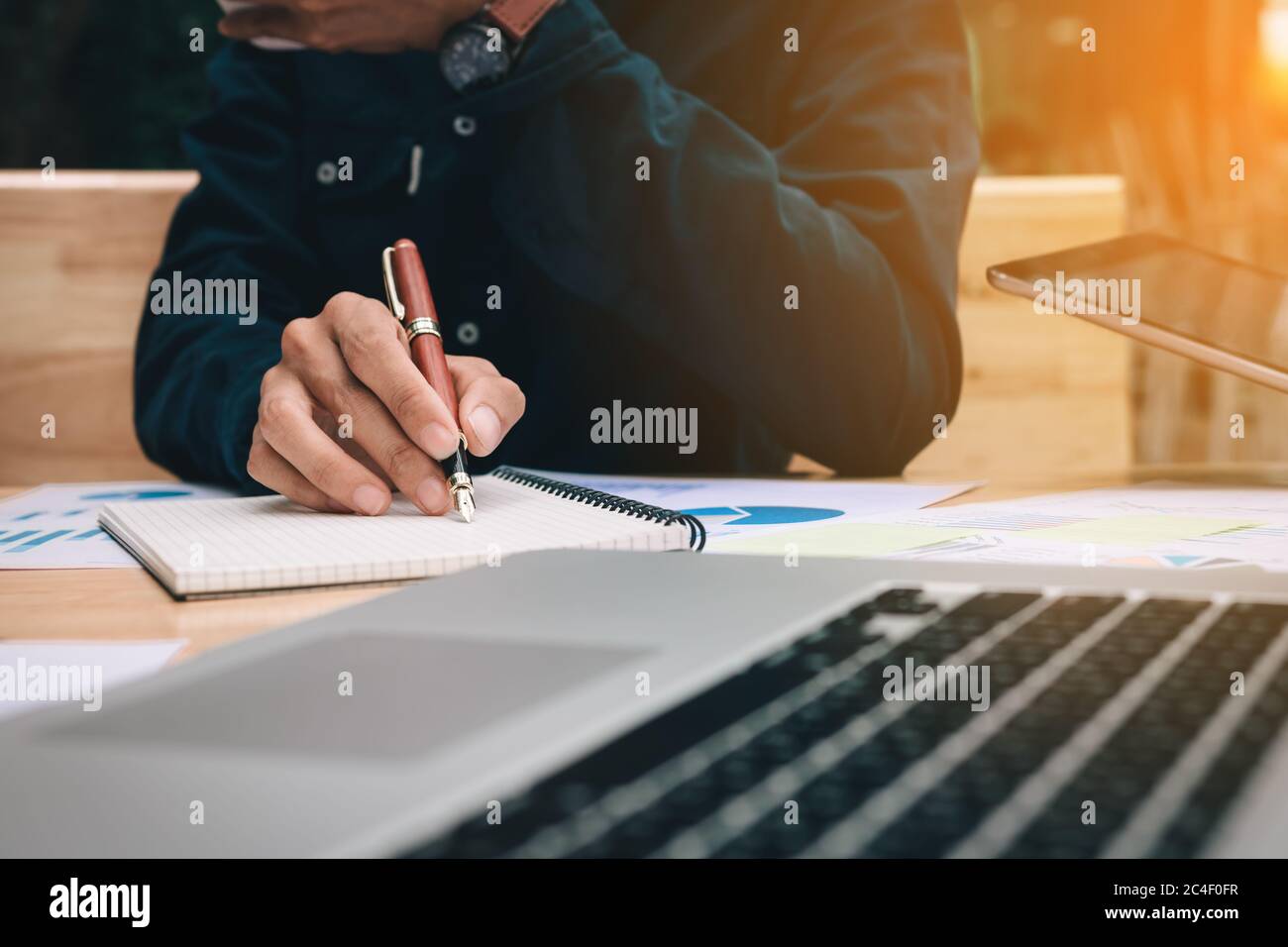 Business man writing make note at office room Stock Photo - Alamy