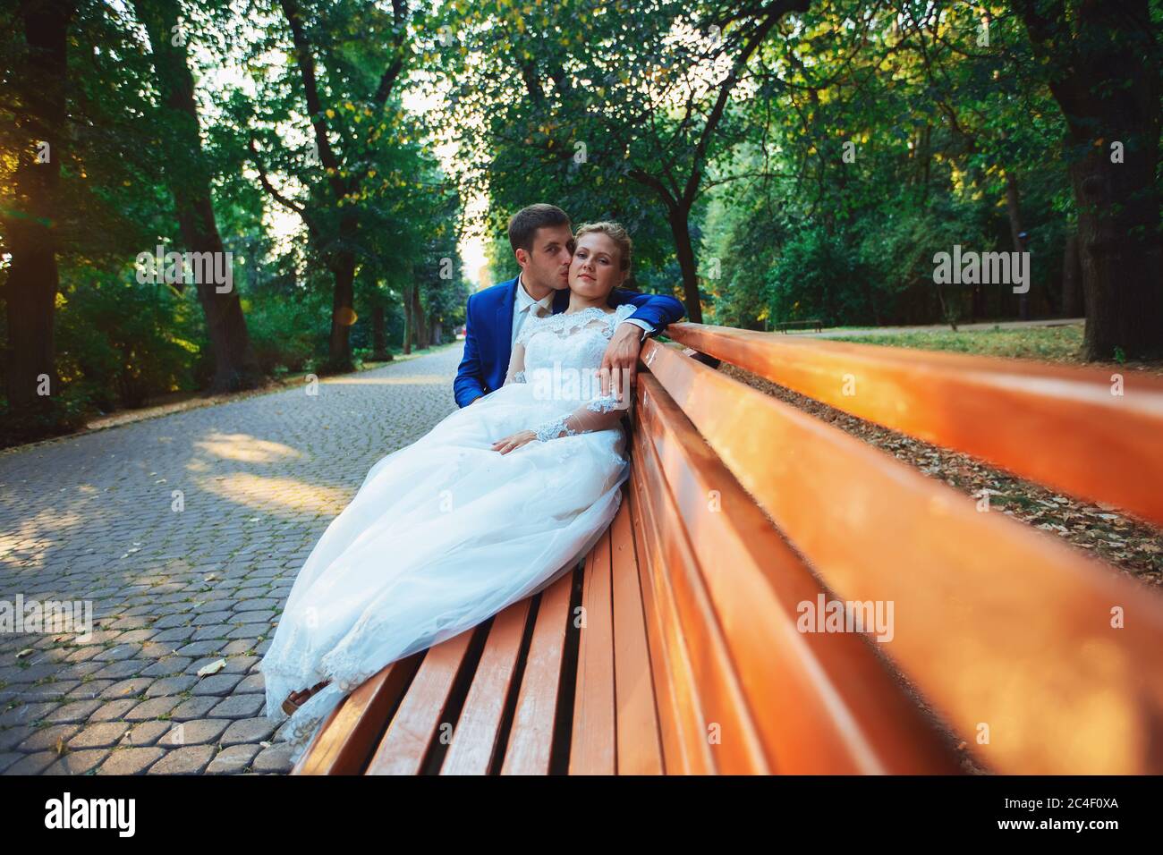 Bride and groom in the park kissing. wedding in nature green forest ...
