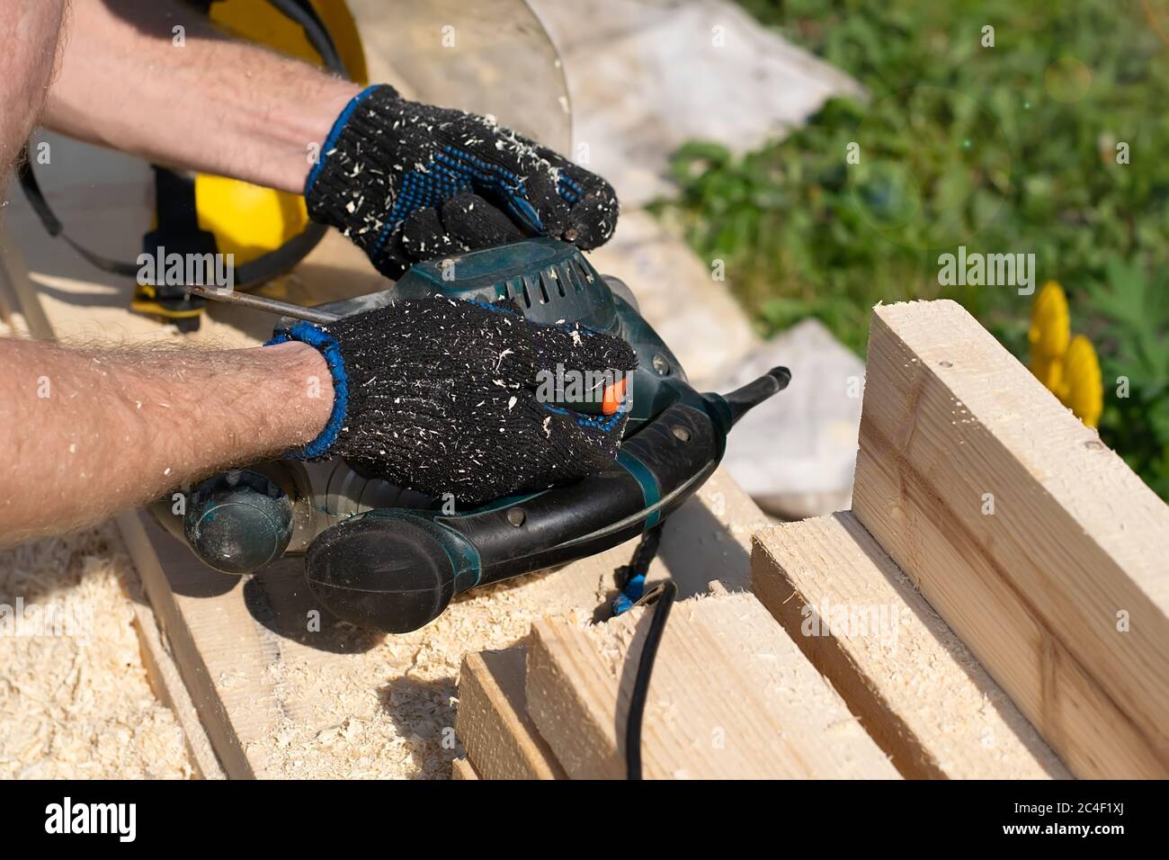 a master, craftsman, carpenter repairs an old broken electric tool for