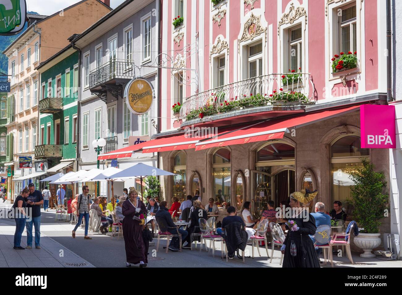 Bad Ischl: Old Town, street Pfarrgasse, women with Goldhaube (Gold cap) in Salzkammergut, Oberösterreich, Upper Austria, Austria Stock Photo