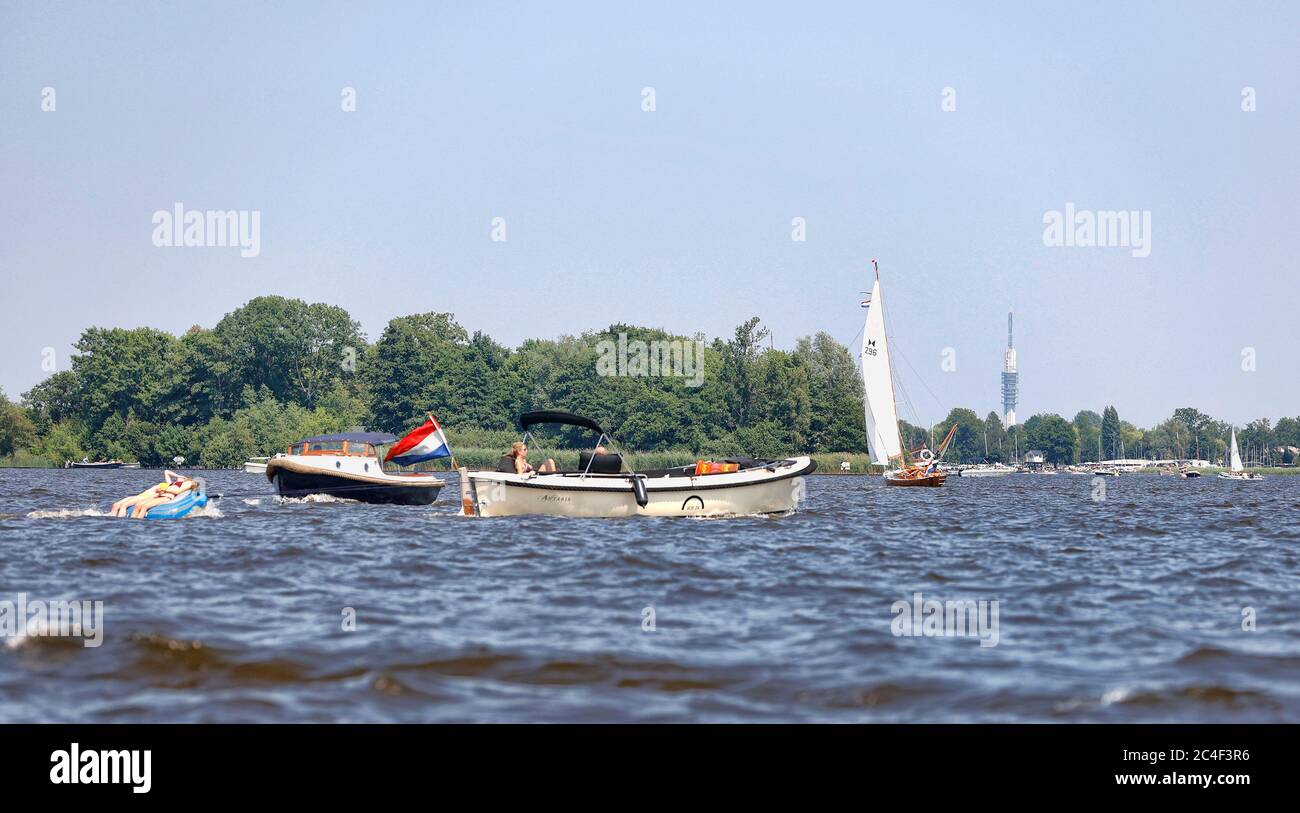 Loosdrecht, Netherlands. 26th June, 2020. LOOSDRECHT, 26-06-2020, Summertime on the lakes of Holland where temperatures reached 30 degrees Celsius. Many people enjoy their freedom after a long period of lockdown due to the coronacrisis. De Loosdrechtse plassen tijdens een warme zomerdag. Vlinder achter de boot Credit: Pro Shots/Alamy Live News Stock Photo
