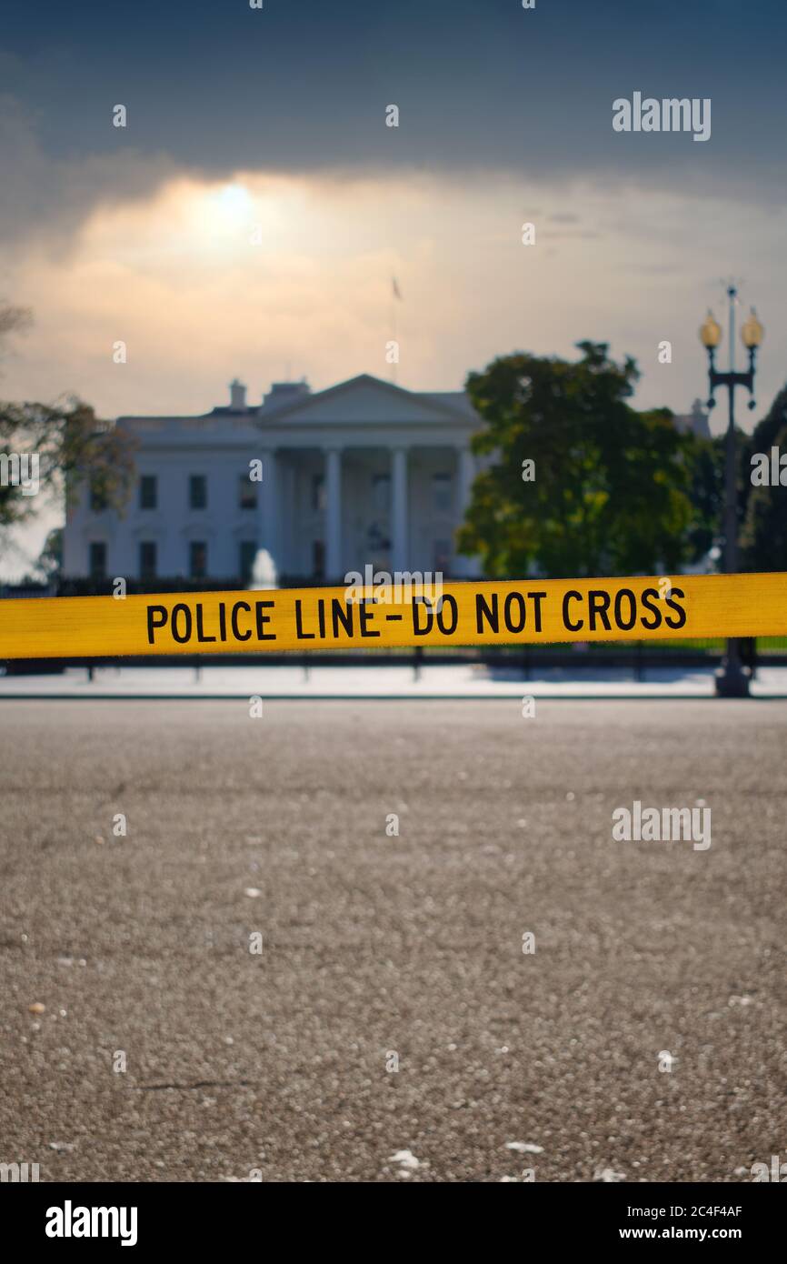 Yellow 'POLICE LINE - DO NOT CROSS' barricade tape in front of the White House, Washington, DC, USA. With copyspace for text. Stock Photo