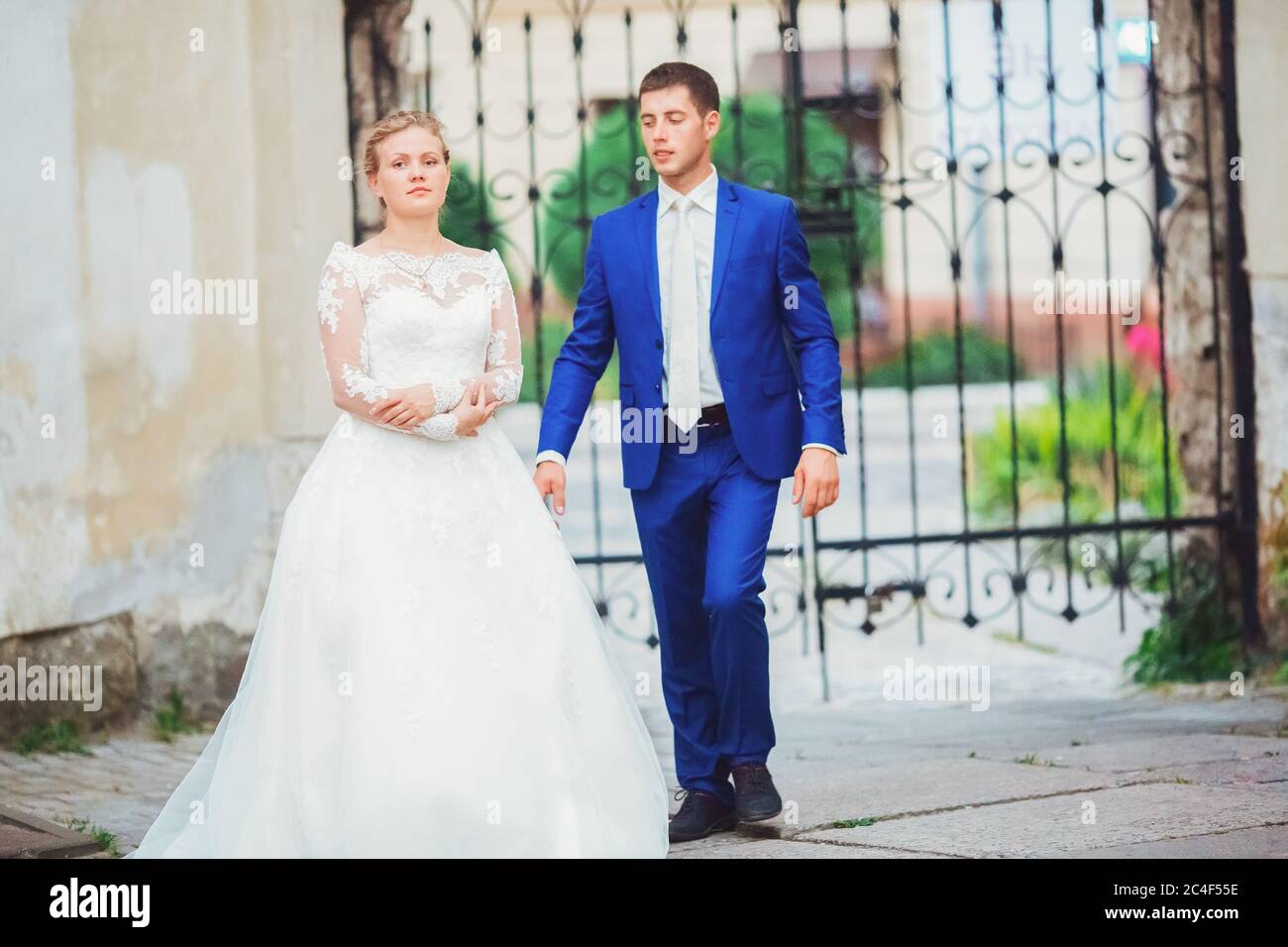 bride and groom walk around the old town Stock Photo - Alamy