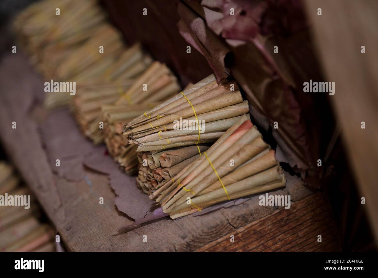 Bundles of Beedi (thin cigarettes). A beedi is filled with tobacco ...