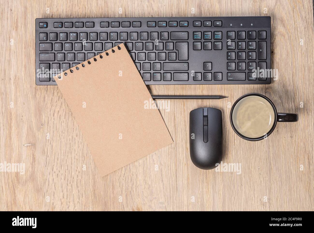 office table with  computer keyboard, mouse, cup of coffee, copy space Stock Photo
