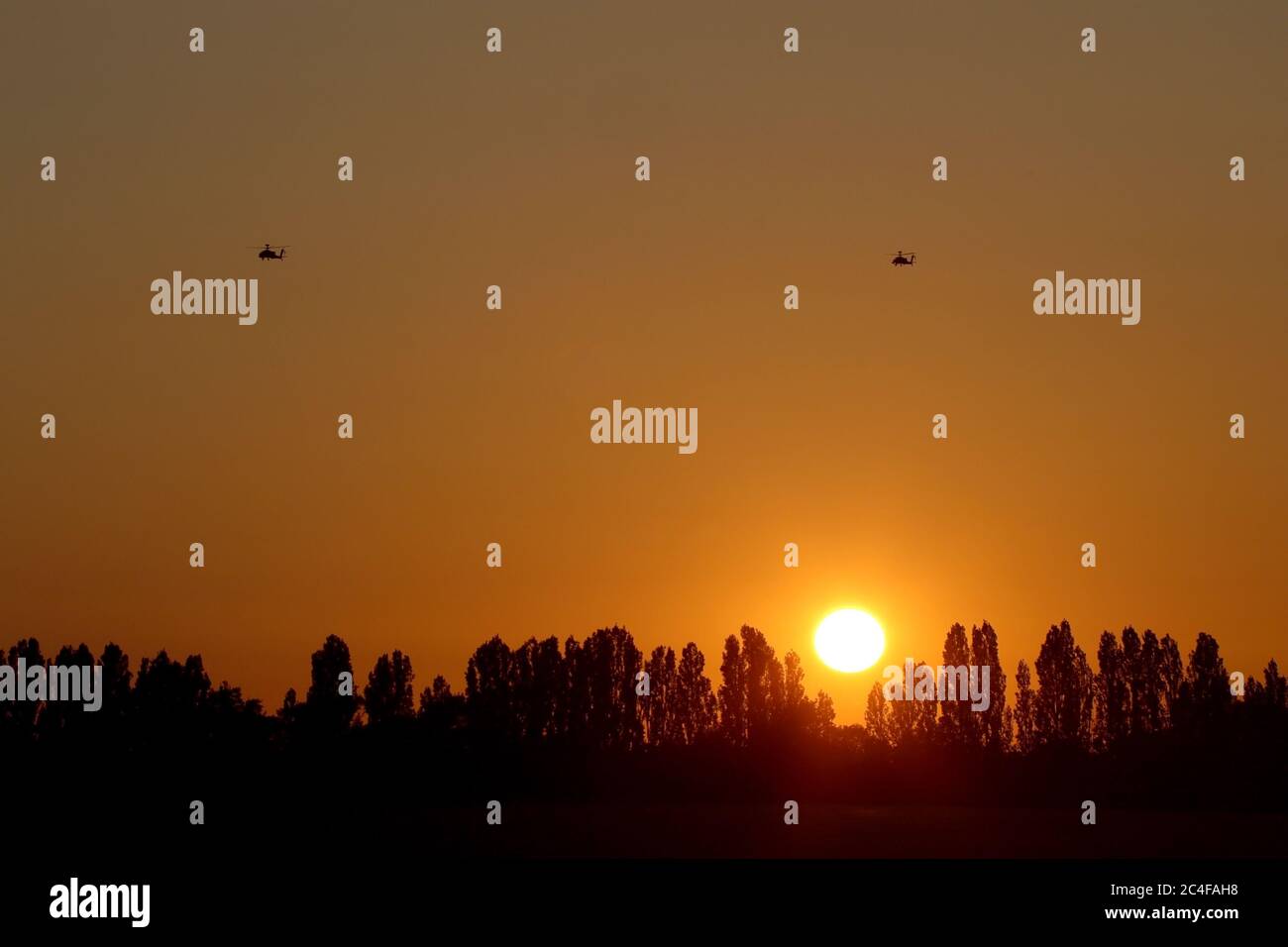 A flight of Army Air Corps Apache helicopters crossing teh skyline as