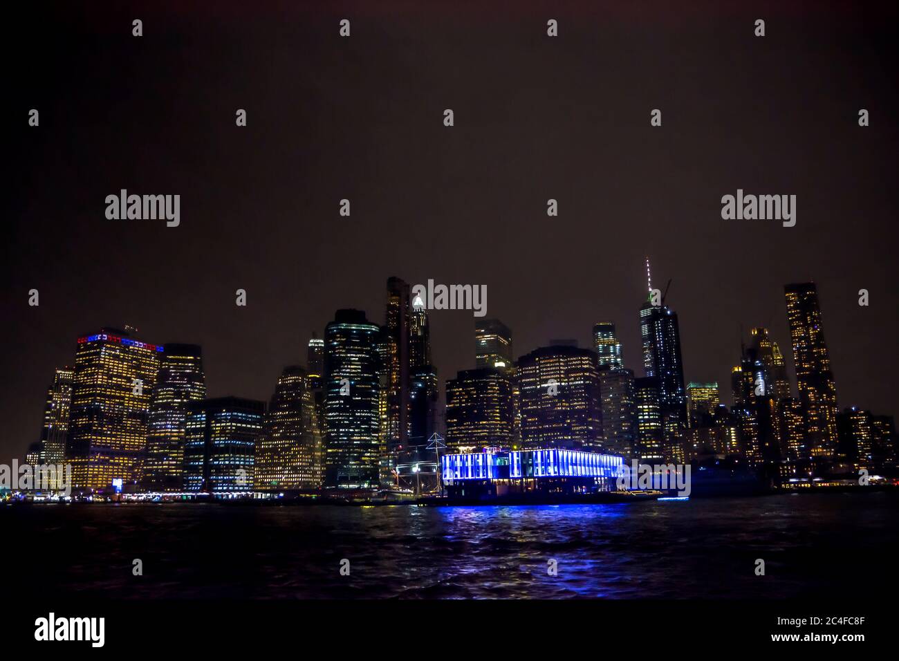 Winter cruise . New York City skyline by night. View from Hudson river ...