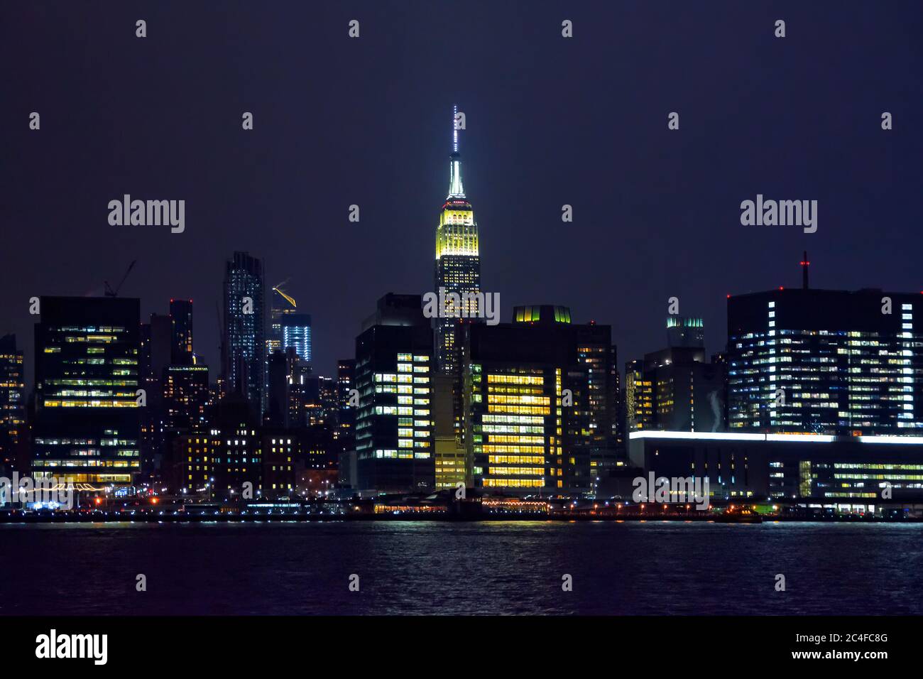 Winter cruise . New York City skyline by night. View from Hudson river ...
