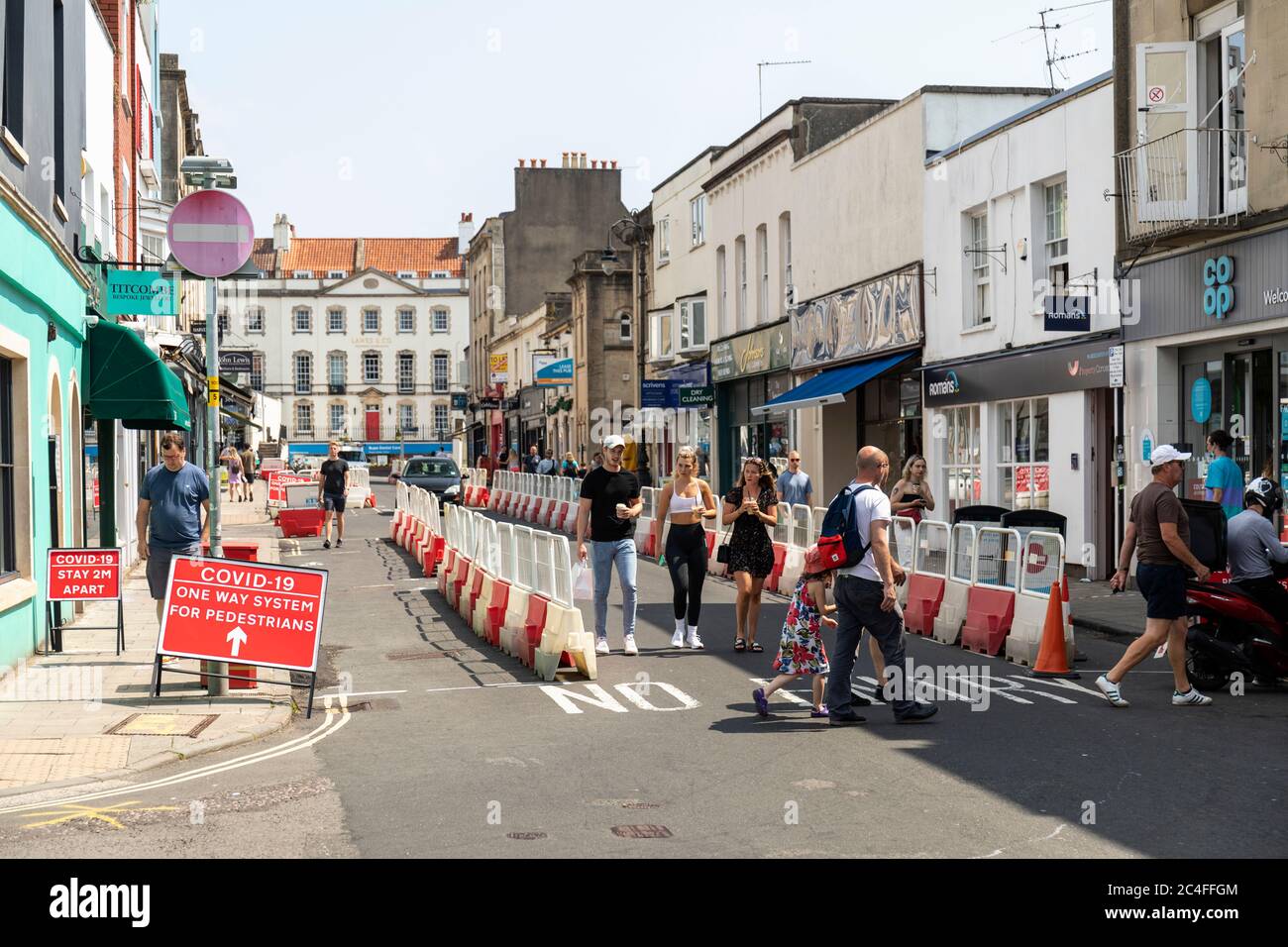 Covid 19 - One way system for pedestrians made by using street barriers to widen the pavements in Clifton Village for social distancing, Bristol, UK Stock Photo