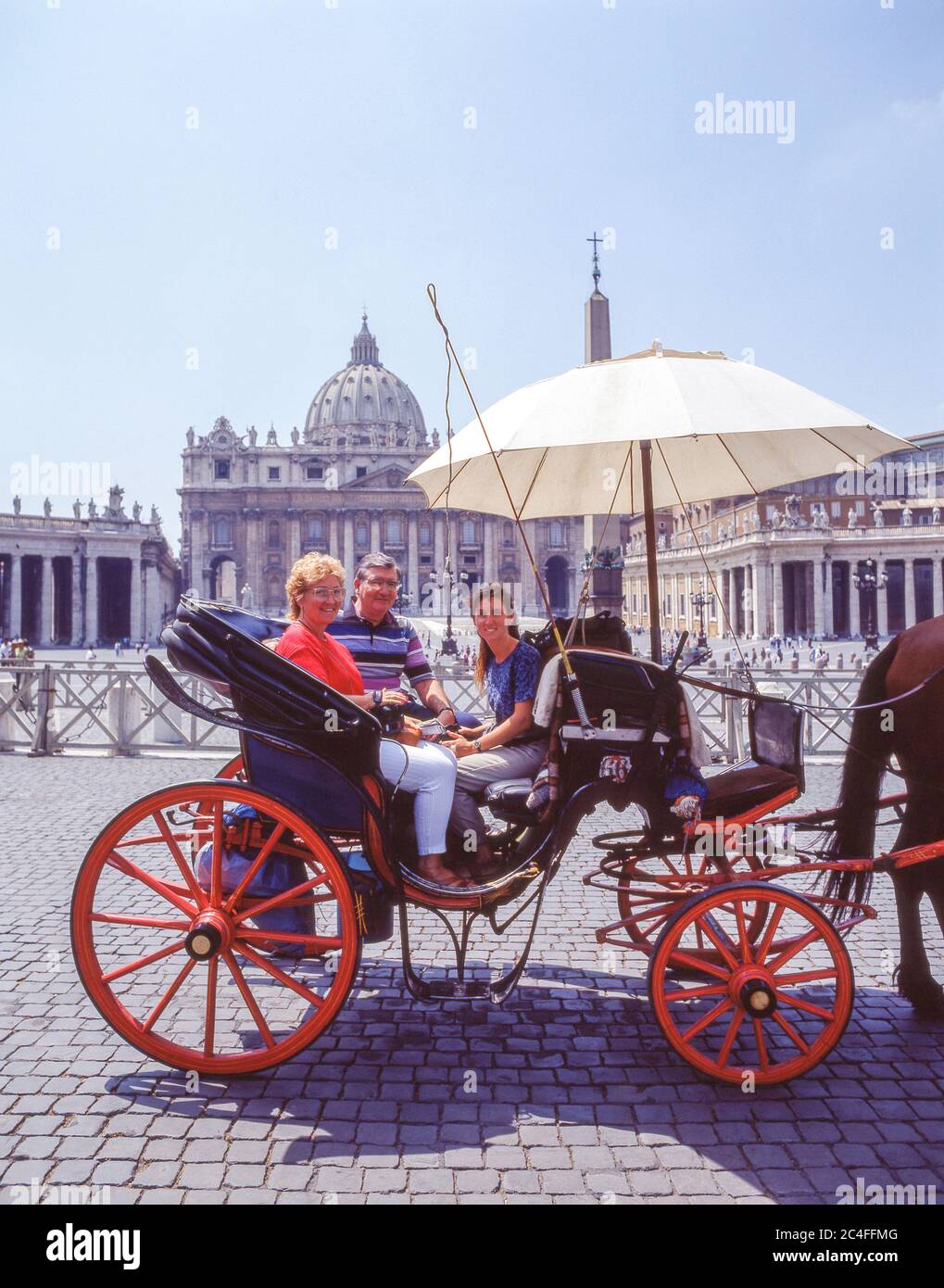 Tourists riding in horse carriage, St Peter's Square, Rome (Roma), Lazio Region, Italy Stock Photo