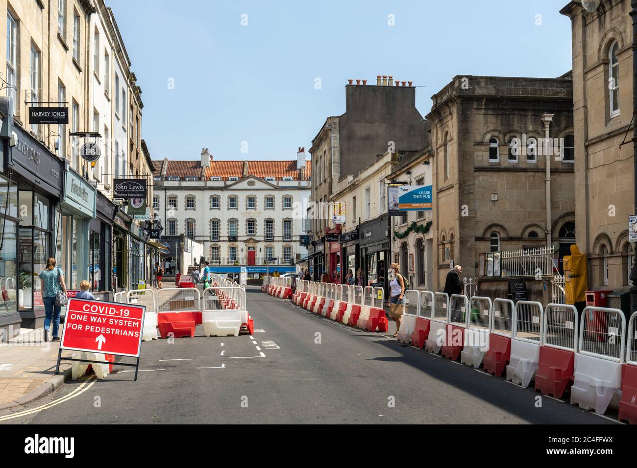 Covid 19 - One way system for pedestrians made by using street barriers to widen the pavements in Clifton Village for social distancing, Bristol, UK Stock Photo