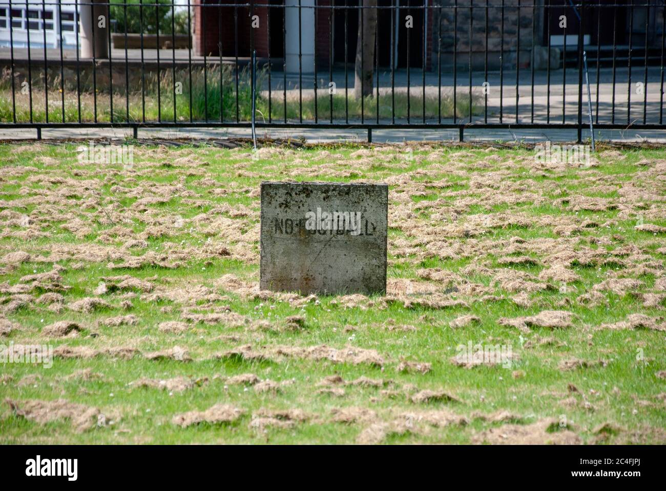 No Football Sign in Field of Grass Glasgow City Centre Scotland United Kingdom grey concrete slab erected in recently cut grass field warning ordering Stock Photo