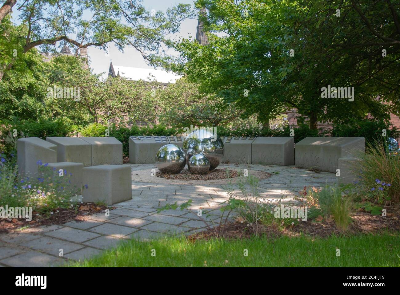 City of Glasgow Council Infant Ashes Memorial Garden three 3 chrome stainless steel spheres surrounded by circles etched carved stone blocks National Stock Photo