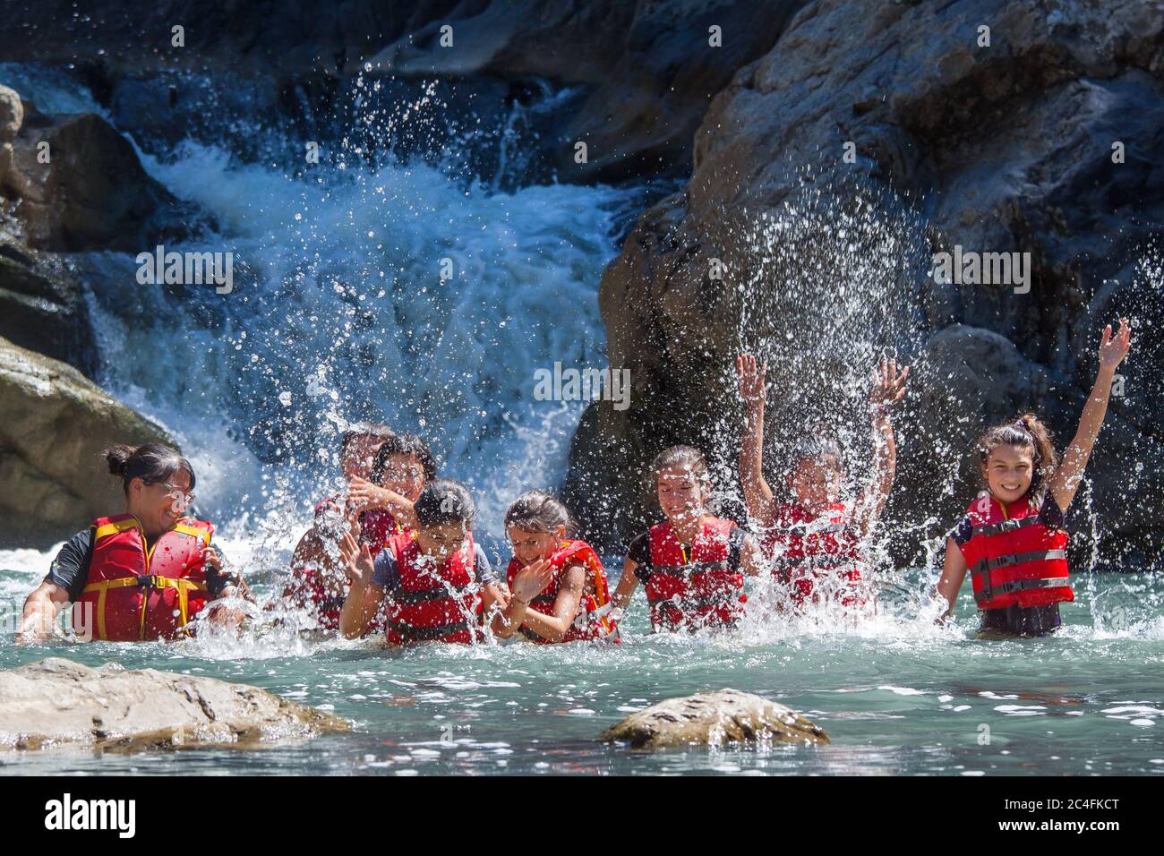 CIUCAS, CLUJ COUNTY, ROMANIA - JULY.11.2016: Children from a socially disadvantaged community taken on a holiday trip playing in the water at a small Stock Photo