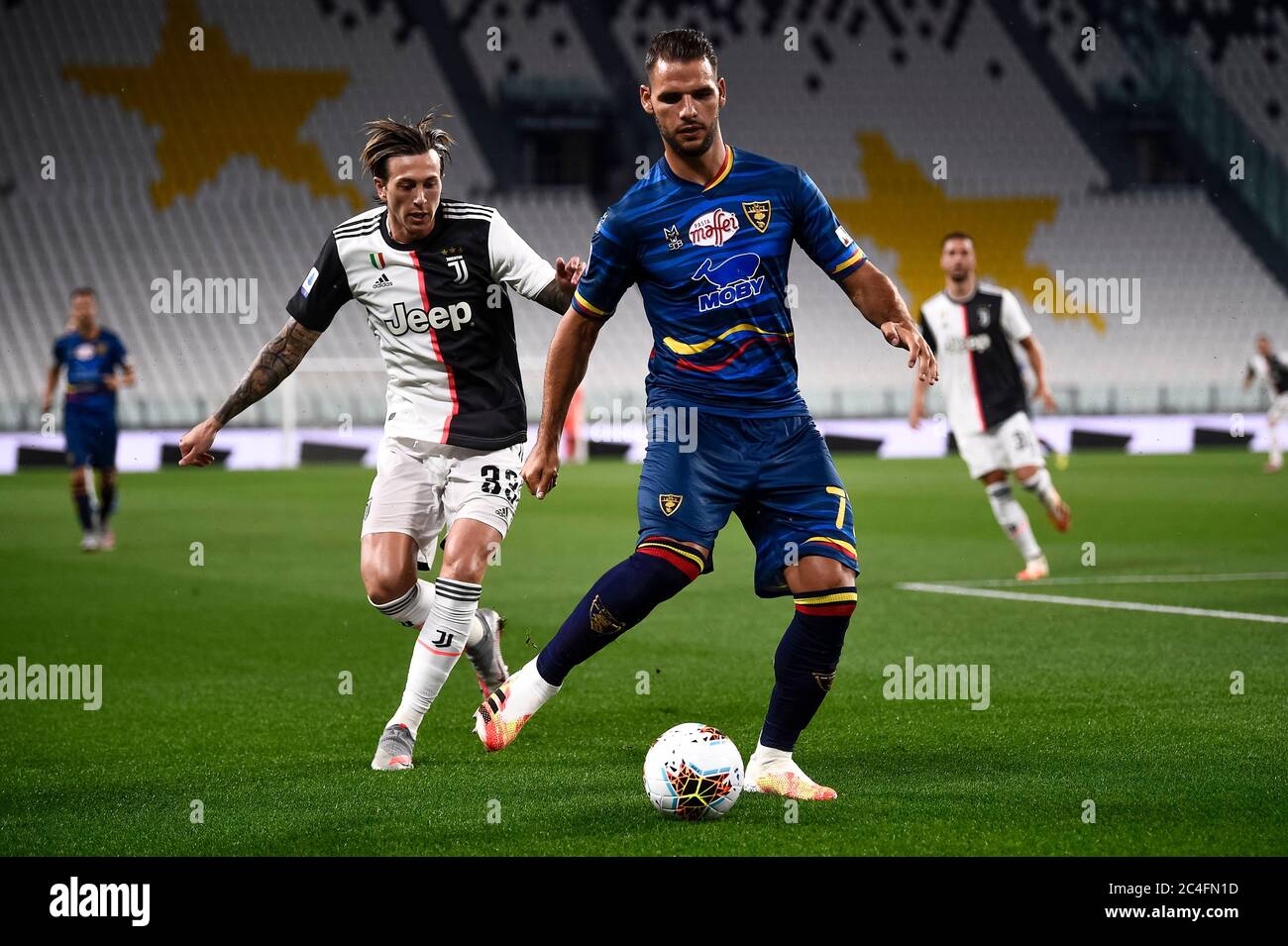 Turin, Italy. 26th June, 2020. TURIN, ITALY - June 26, 2020: Panagiotis Tachtsidis of US Lecce is challenged by Federico Bernardeschi of Juventus FC during the Serie A football match between Juventus FC and US Lecce. (Photo by Nicolò Campo/Sipa USA) Credit: Sipa USA/Alamy Live News Stock Photo