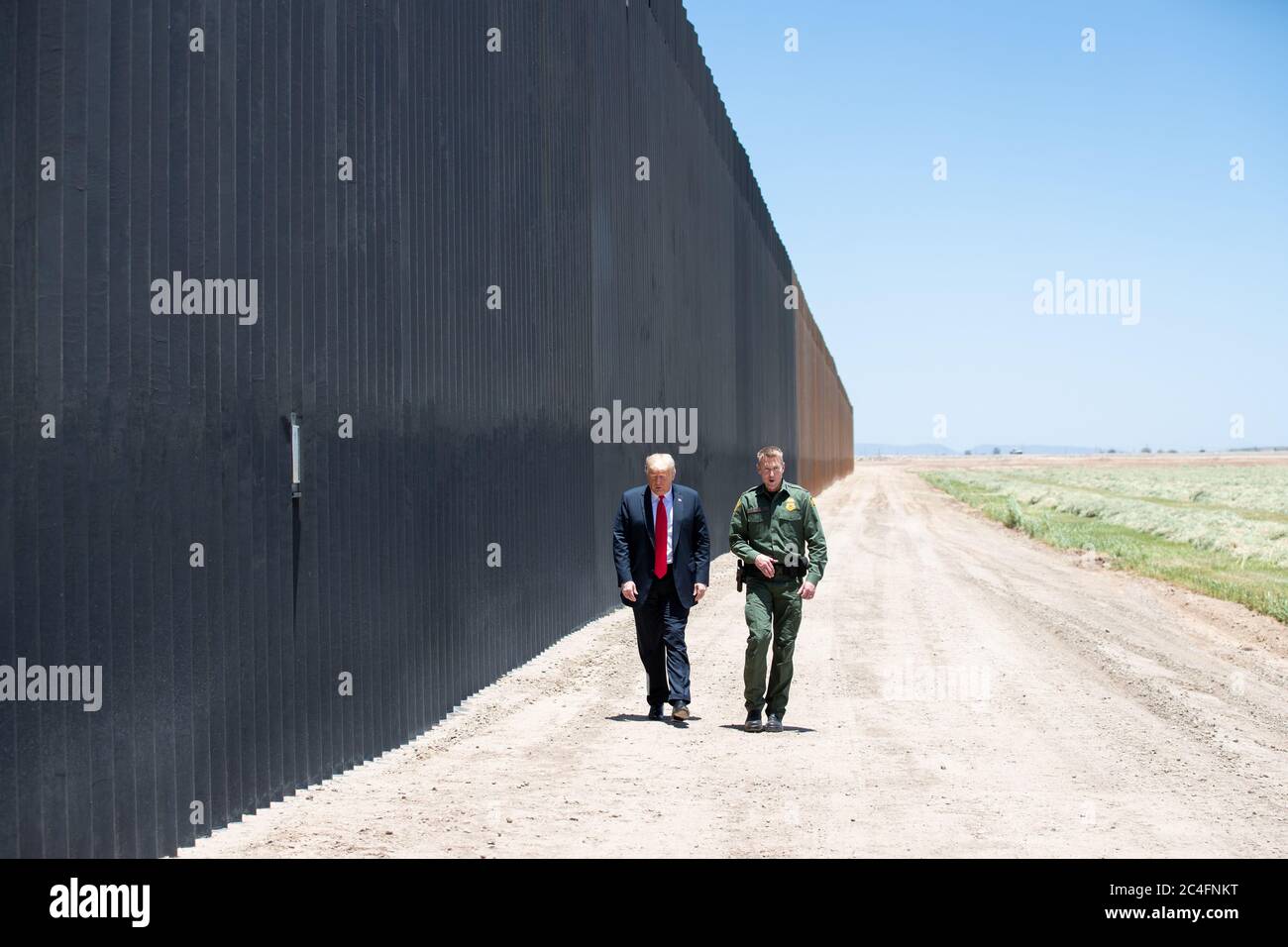 U.S. President Donald Trump is given a tour of a new section of border wall along the Mexican-American border by Border Patrol chief Rodney Scott June 23, 2020 in San Luis, Arizona. The visit marked the completion of 200 miles of border wall, the majority of which is replacement for existing structure at a cost of $20-million dollars a mile. Stock Photo