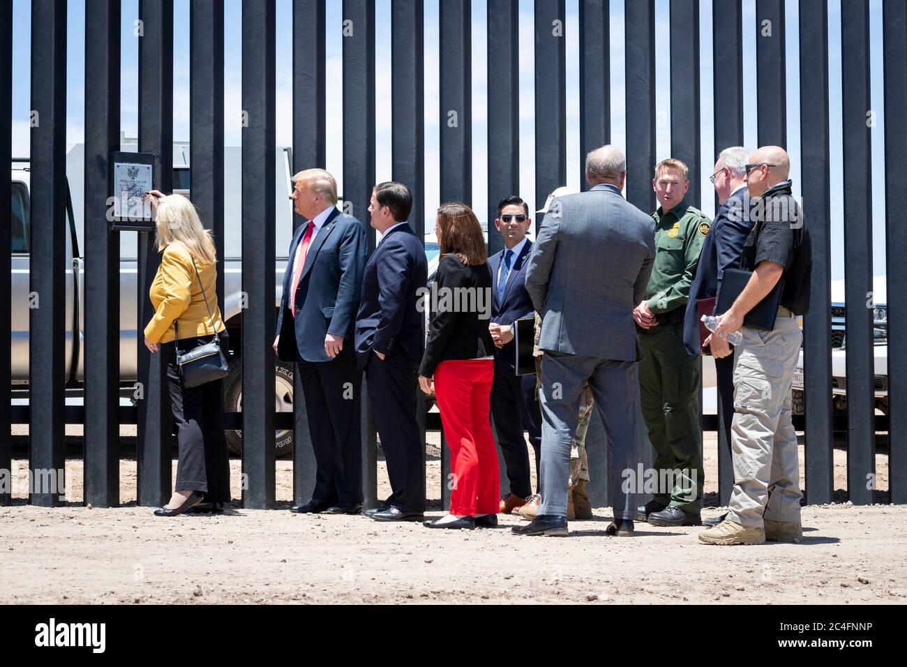 Rep. Debbie Lesko, left, signs the border wall as U.S. President Donald Trump, Arizona Gov. Doug Ducey, Acting DHS Secretary Chad Wolf and Acting CBP Commissioner Mark Morgan, look on, along the Mexican-American border June 23, 2020 in San Luis, Arizona. The visit marked the completion of 200 miles of border wall, the majority of which is replacement for existing structure at a cost of $20-million dollars a mile. Stock Photo