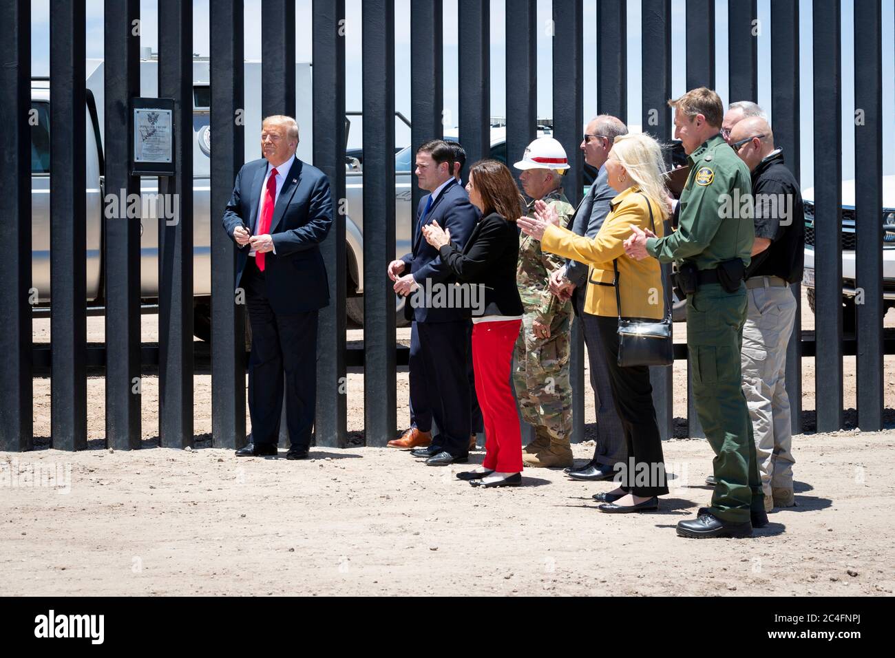 U.S. President Donald Trump is applauded by Arizona Gov. Doug Ducey, Acting DHS Secretary Chad Wolf, Rep. Debbie Lesko, Senator Martha McSally and Acting CBP Commissioner Mark Morgan during a visit to the Mexican-American border June 23, 2020 in San Luis, Arizona. The visit marked the completion of 200 miles of border wall, the majority of which is replacement for existing structure at a cost of $20-million dollars a mile. Stock Photo