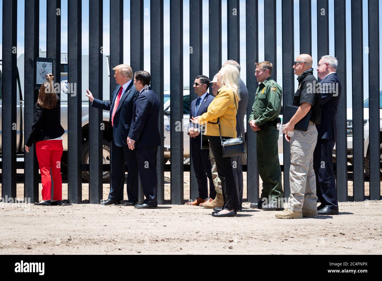 Senator Martha McSally, left, signs the border wall as U.S. President Donald Trump, Arizona Gov. Doug Ducey, Acting DHS Secretary Chad Wolf, Rep. Debbie Lesko and Acting CBP Commissioner Mark Morgan, look on, along the Mexican-American border June 23, 2020 in San Luis, Arizona. The visit marked the completion of 200 miles of border wall, the majority of which is replacement for existing structure at a cost of $20-million dollars a mile. Stock Photo