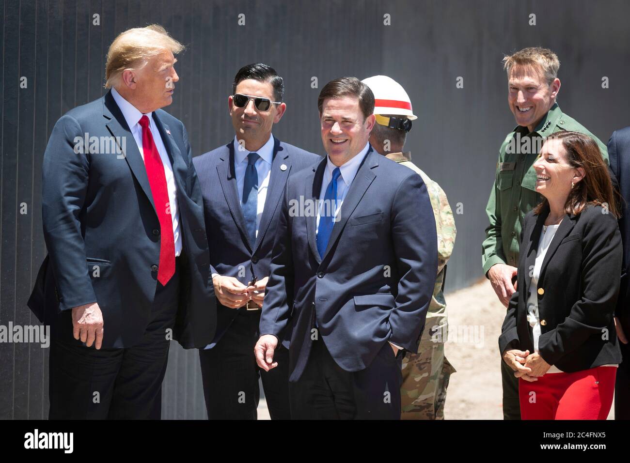 U.S. President Donald Trump tours a new section of border wall along the Mexican-American border June 23, 2020 in San Luis, Arizona. Joining the president from left to right are: Acting DHS Secretary Chad Wolf, Arizona Gov. Doug Ducey, Lieutenant General Todd Semonite, Border Patrol chief Rodney Scott and Senator Martha McSally. Stock Photo