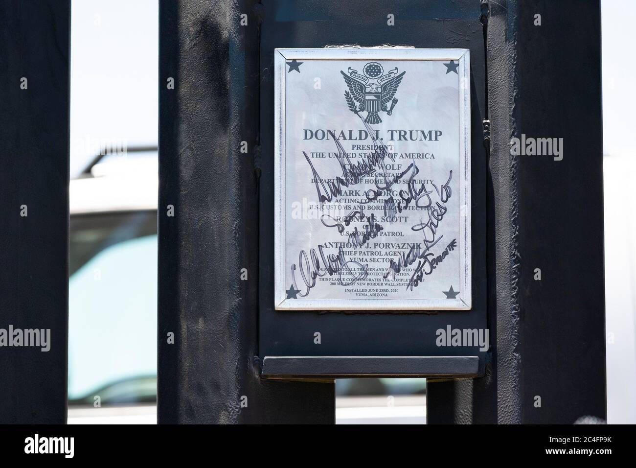 A commemorative plaque signed by U.S. President Donald Trump on a new section of border wall along the Mexican-American border June 23, 2020 in San Luis, Arizona. Stock Photo