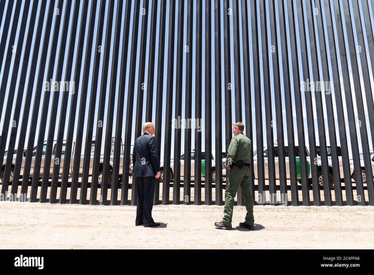 U.S. President Donald Trump is given a tour of a new section of border wall along the Mexican-American border by Border Patrol chief Rodney Scott June 23, 2020 in San Luis, Arizona. The visit marked the completion of 200 miles of border wall, the majority of which is replacement for existing structure at a cost of $20-million dollars a mile. Stock Photo