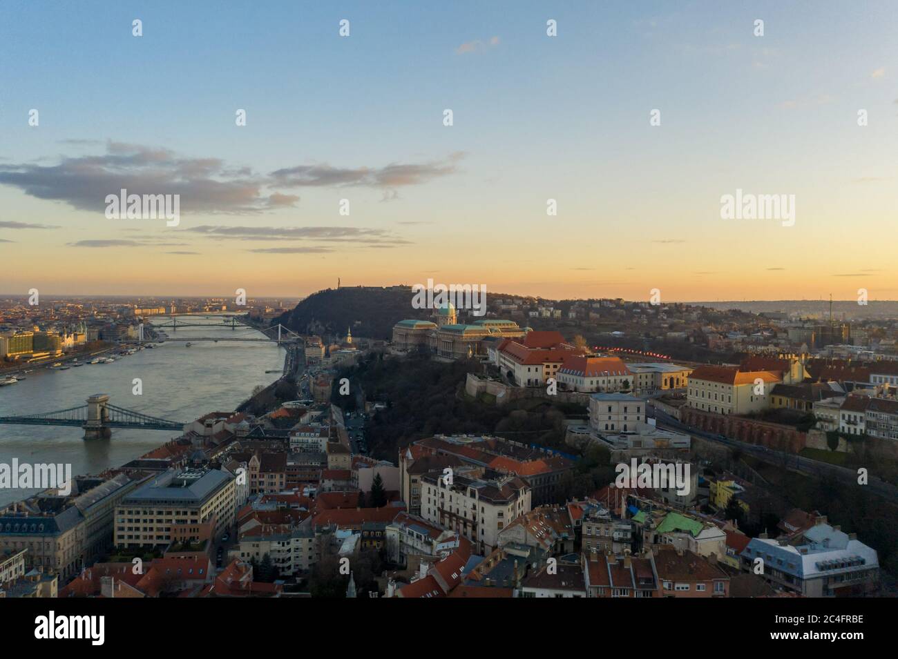 Aerial drone shot of Buda castle on hill during Budapest sunset hour ...
