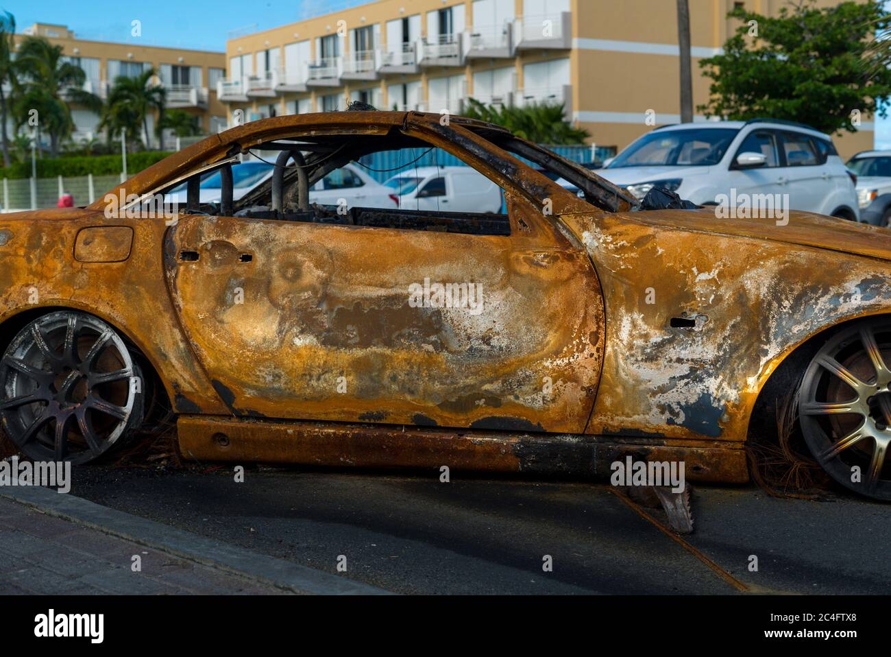 Protesters burn vehicles to block the main road on french Saint Martin. The Main protest is against the natural risk prevention plan (PPRN) decision t Stock Photo