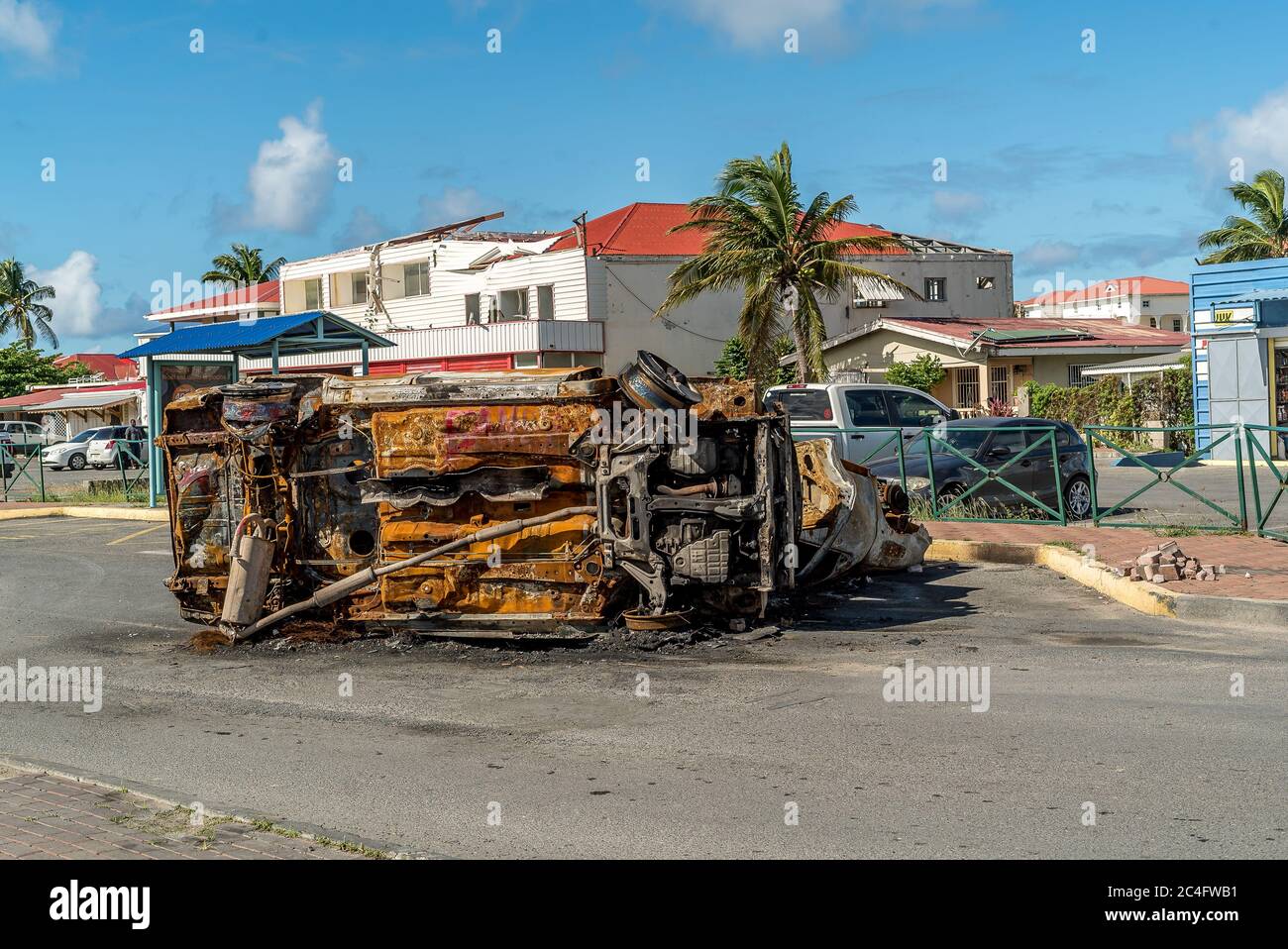 Protesters burn vehicles to block the main road on french Saint Martin. The Main protest is against the natural risk prevention plan (PPRN) decision t Stock Photo