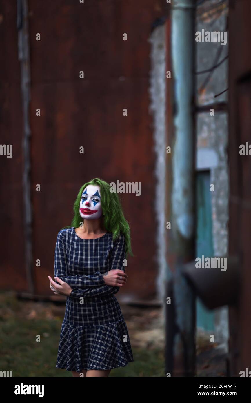 Portrait Of A Greenhaired Girl In Chekered Dress With Joker Makeup On A Atmospheric Rusty Metal Wall Background Stock Photo Alamy