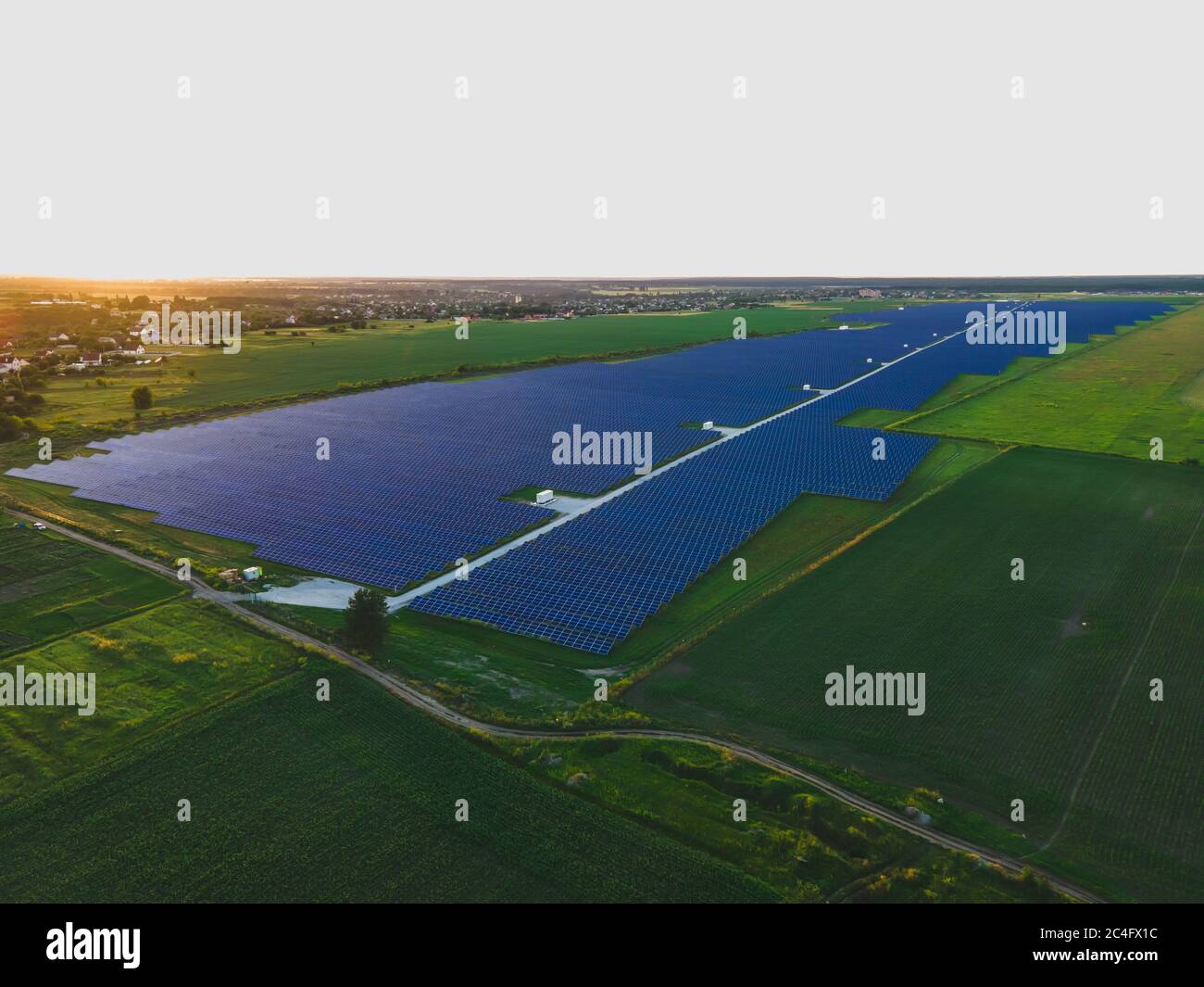 Aerial drone view of large solar panels at a solar farm at bright ...