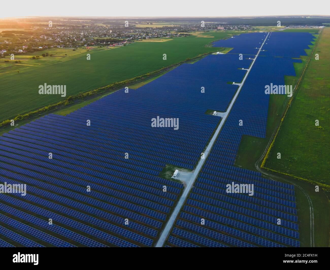 Aerial drone view of large solar panels at a solar farm at bright ...