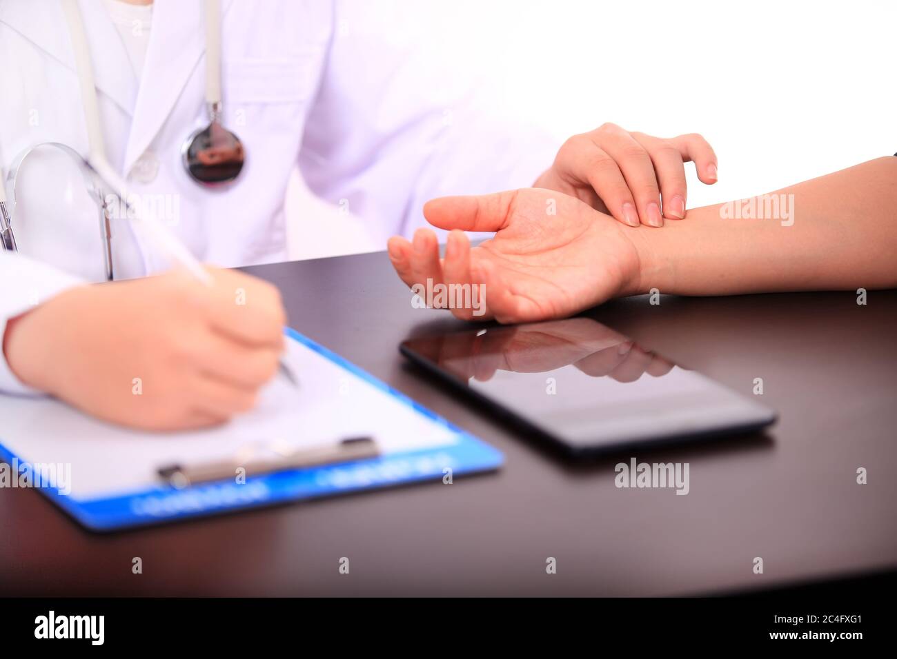 doctor or nurse measuring patient pulse Stock Photo
