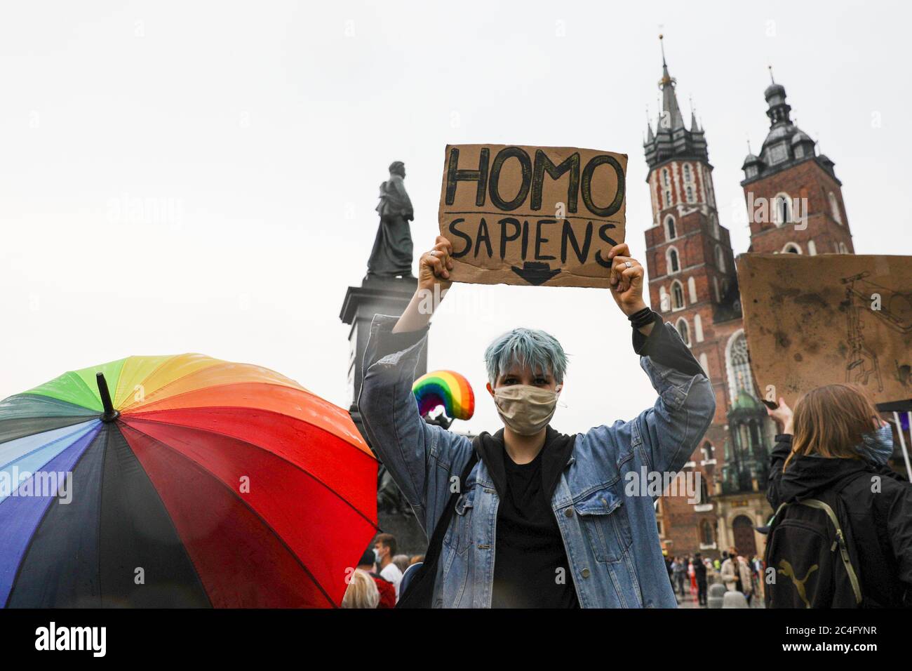 Protester holding a placard saying 'Homo Sapiens' during the counter-demonstration.In support of current President of Poland, Andrzej Duda who is applying for presidential re-elections to be held on 28 June, a political rally was held. The rally was accompanied by his stable electorate seniors and conservative small town dwellers. A counter-protest was held against Duda's homophobic statements. Stock Photo