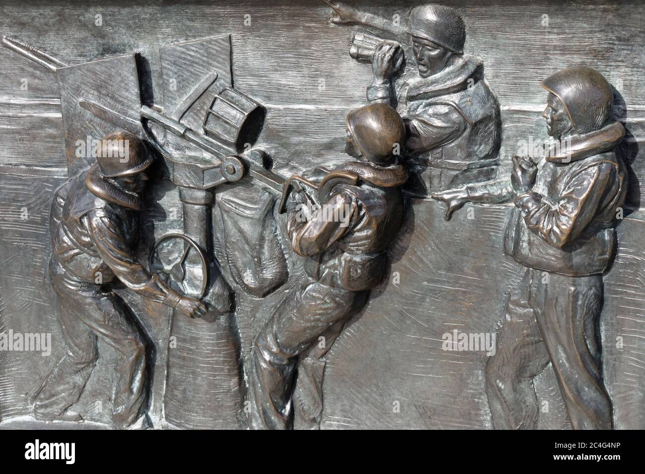 U.S. soldiers firing anti aircraft gun during the Battle of the Atlantic. Bronze bas-relief located on the World War II Memorial, Washington, DC, USA. Stock Photo