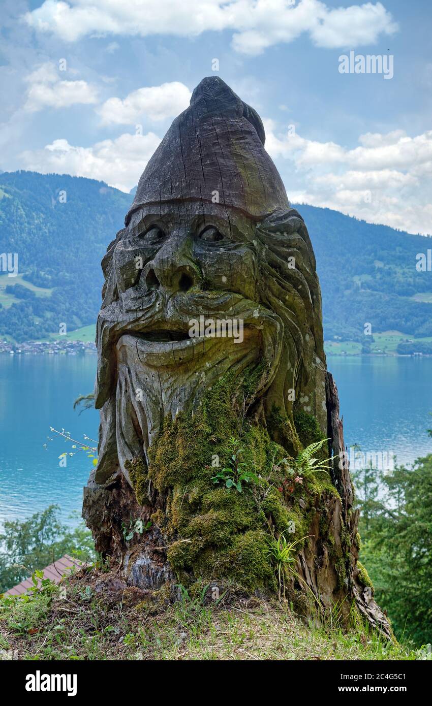 Old gnome or dwarf statue made of wood, located near Interlaken and St.  Beatus Caves above the Lake Thun, Canton of Bern, Switzerland Stock Photo -  Alamy
