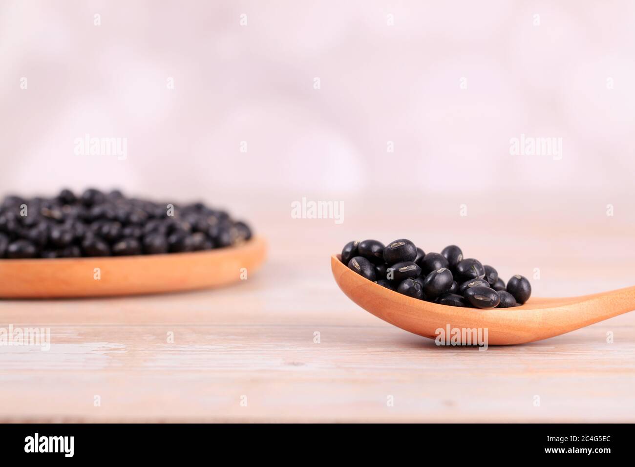 The black beans are on the wooden table Stock Photo