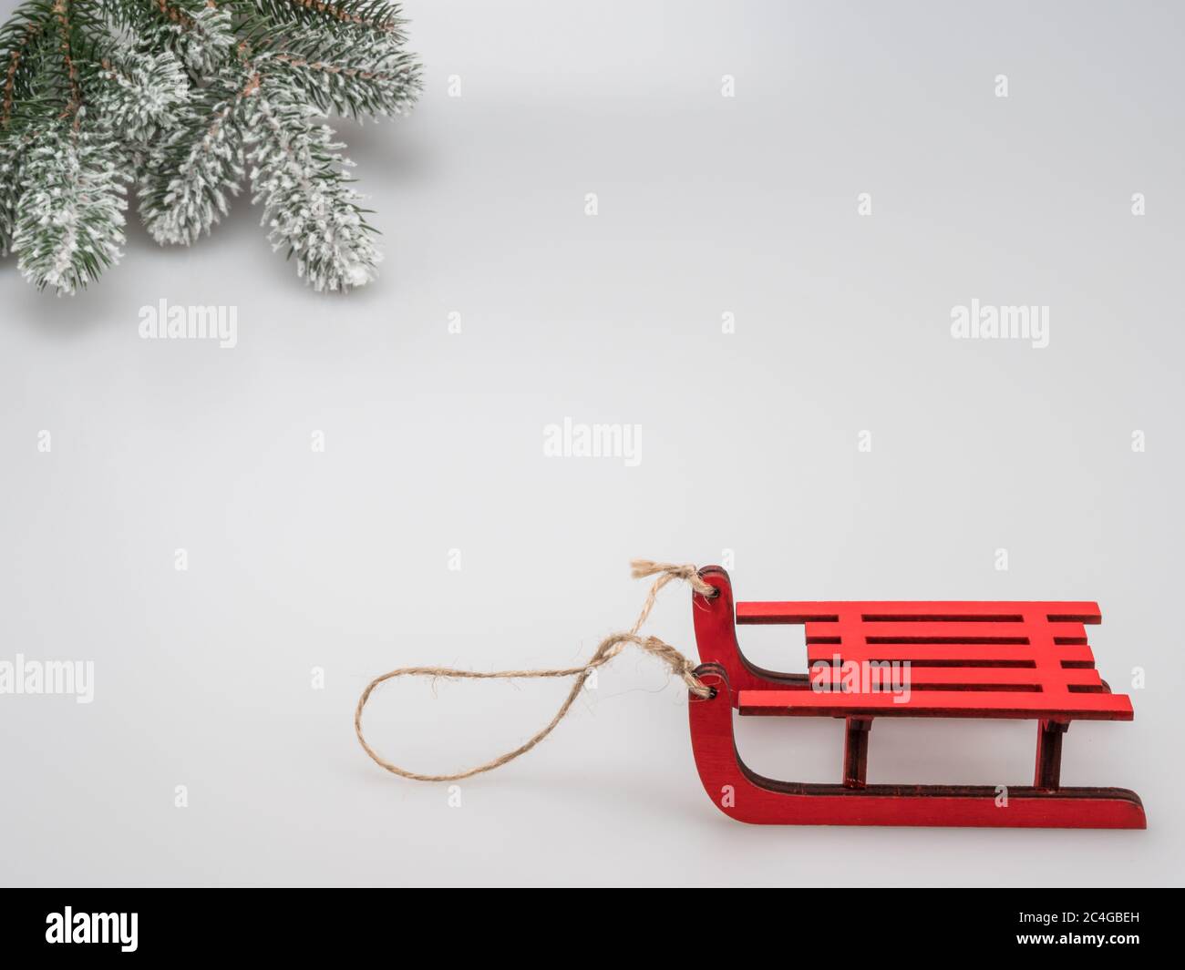Winter postcard. Sledges and snow-covered branch of a tree. Stock Photo