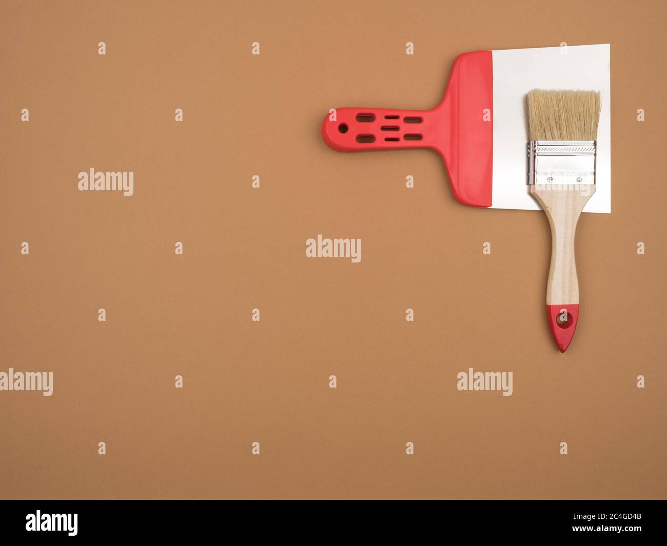 Construction tools on a beige background. Brush and spatula. Stock Photo