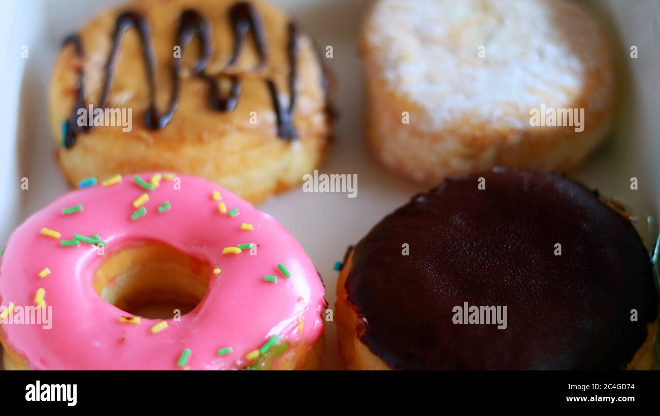 Colorful sweet glazed donuts from bakery Stock Photo - Alamy