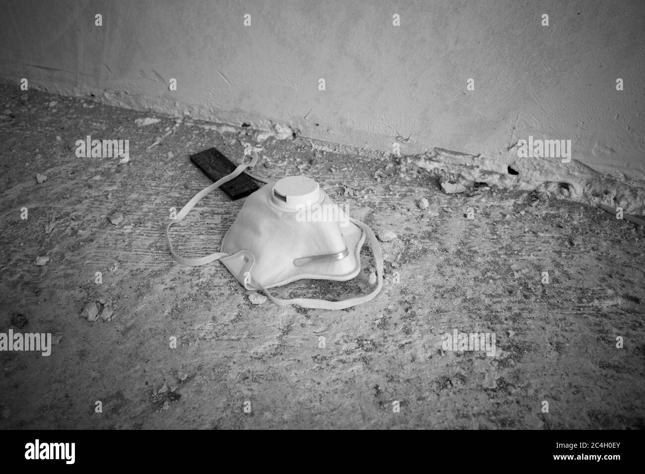 there is a discarded breathing mask on the floor Stock Photo