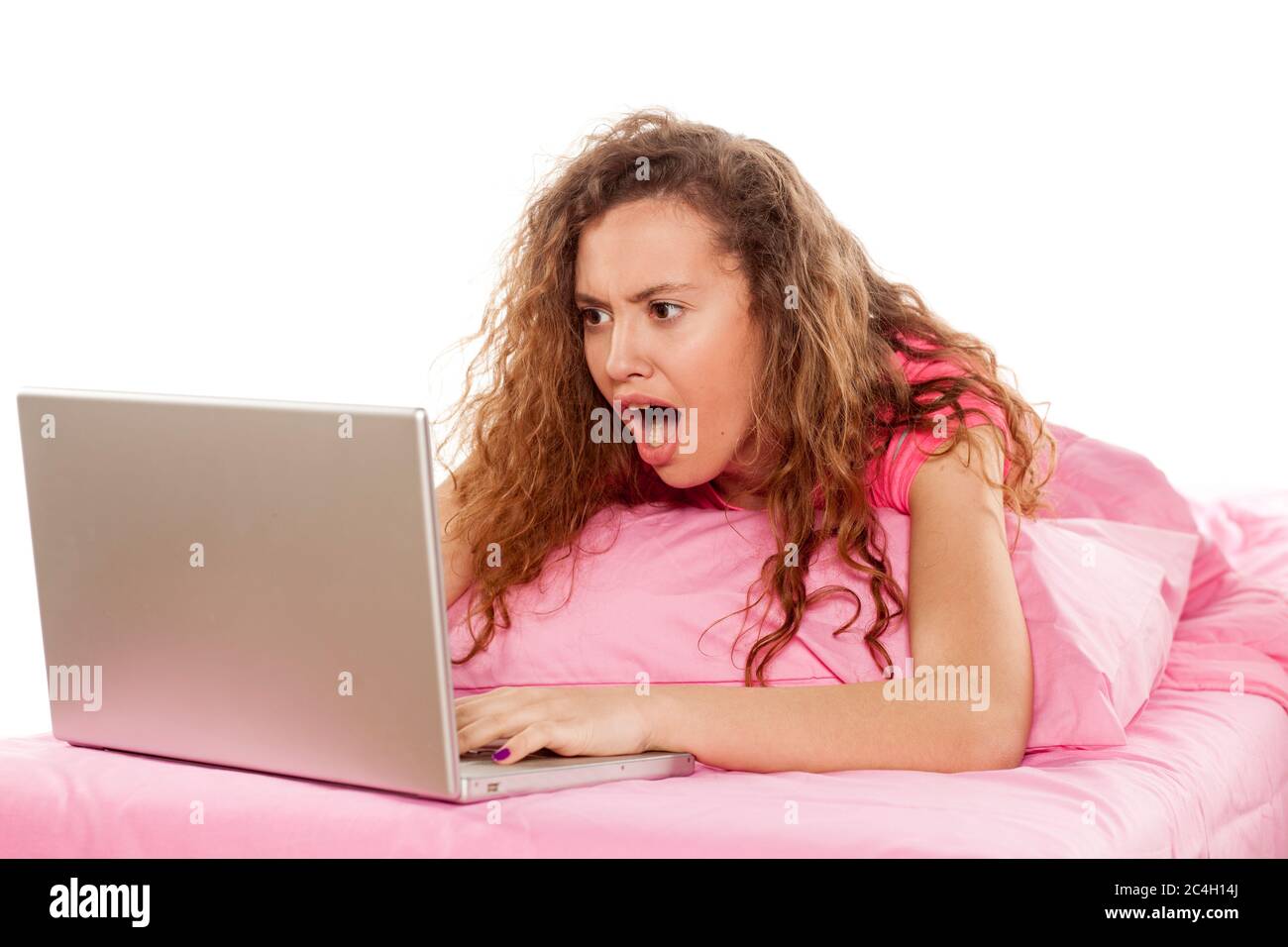 shocked girl looking at her laptop Stock Photo