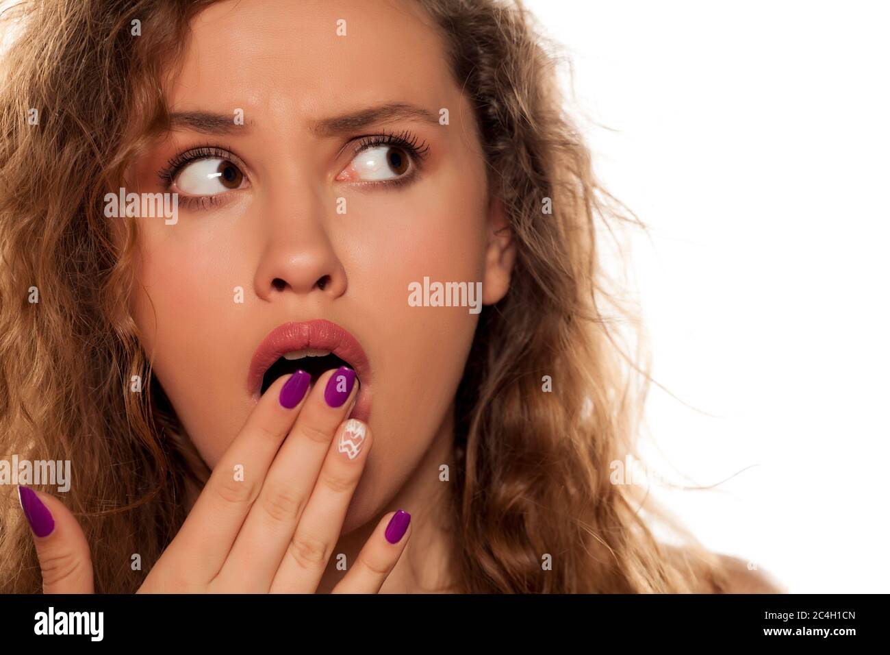 shocked young woman on white background Stock Photo