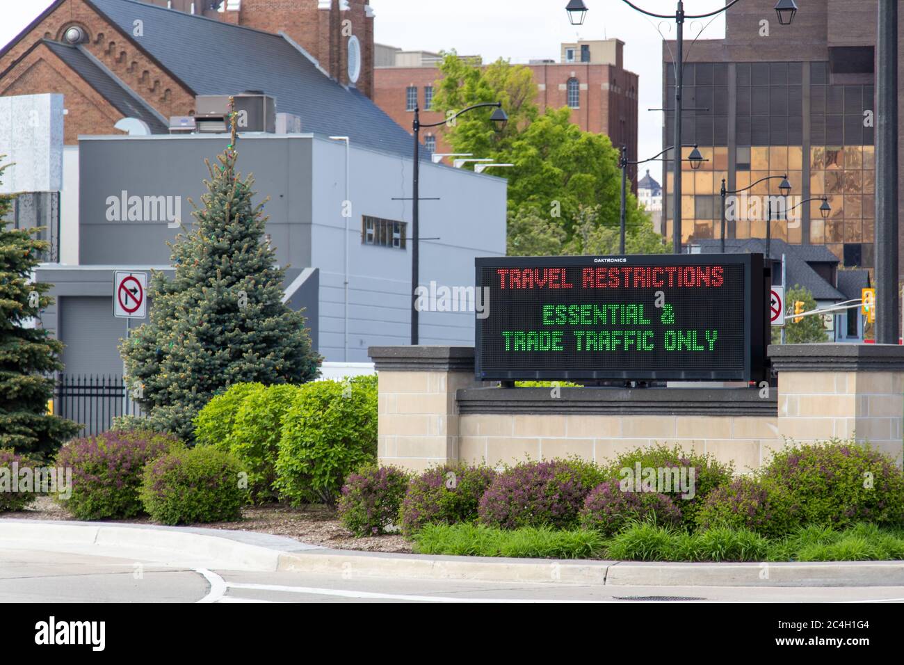 'Travel Restrictions - Essential & Trade Traffic Only' sign at the entrance to the Detroit-Windsor, US-Canada Border crossing during the ongoing COVID Stock Photo
