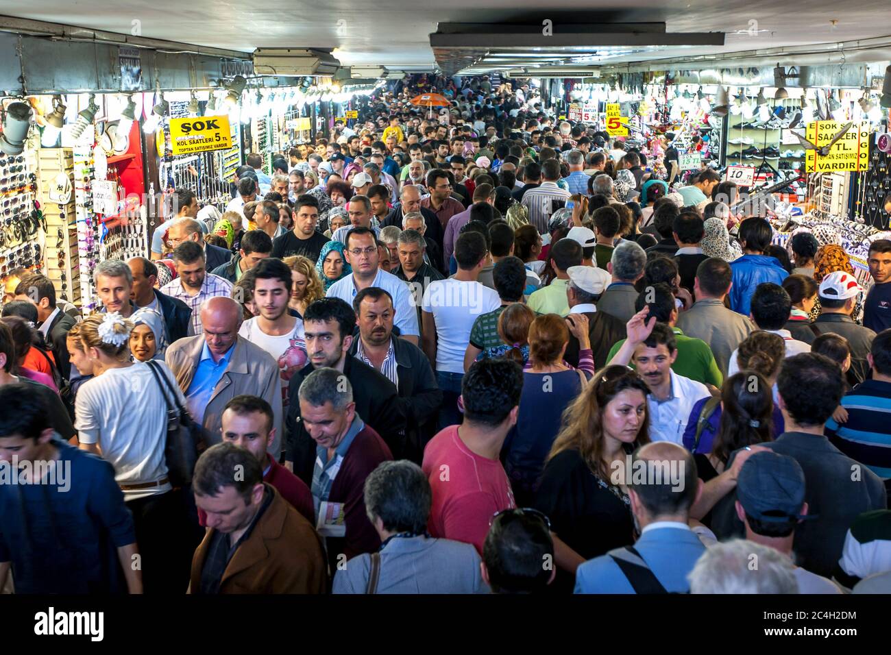 A mass of people move through an underpass at Eminonu in Istanbul in Turkey. The underpass is congested even more as people stop at the various stores Stock Photo