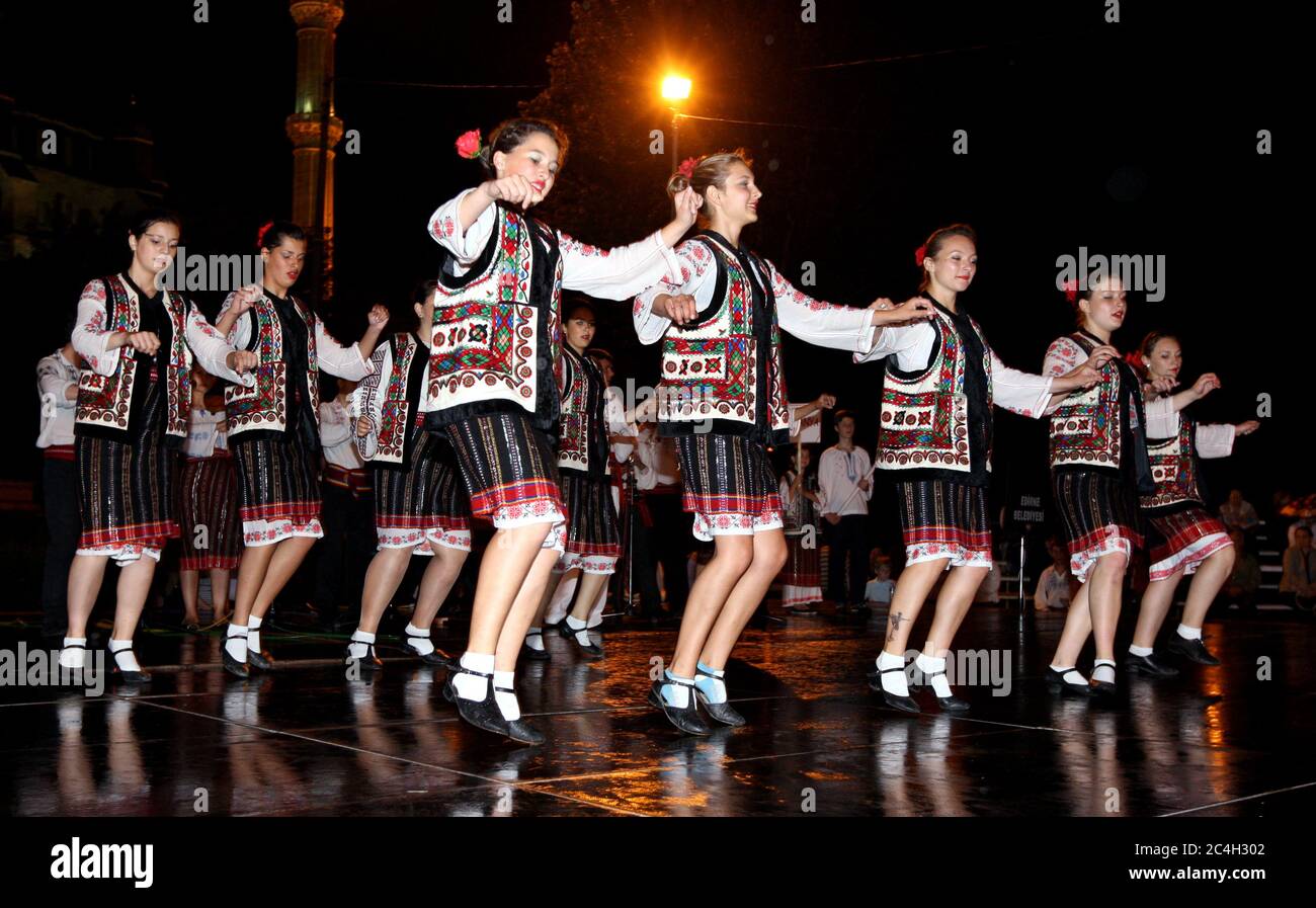 Folk dancers perform as part of outdoor night time entertainment during the Kirkpinar Turkish Oil Wrestling Festival at Edirne in Turkey. Stock Photo