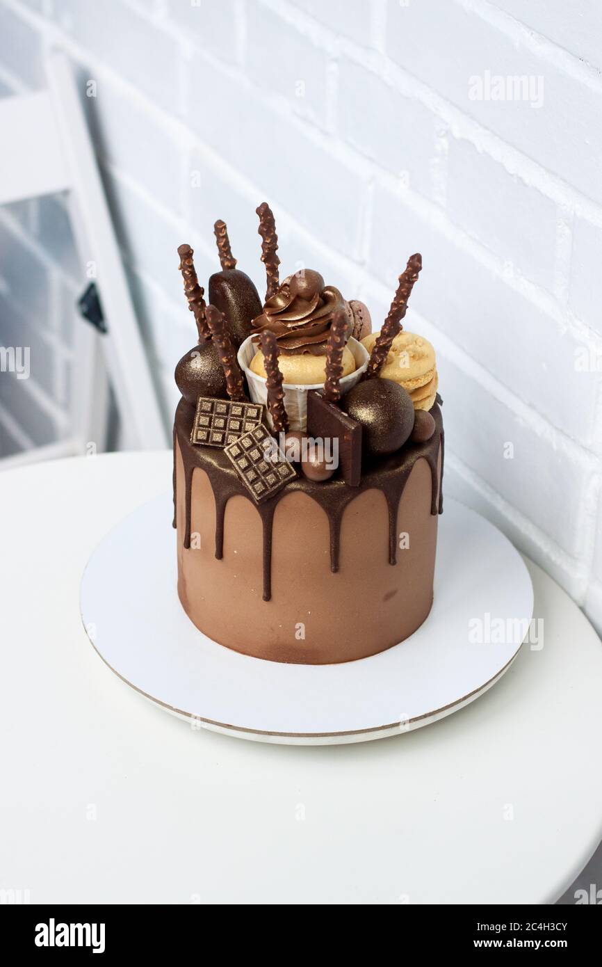 Elegant chocolate birthday cake with melted dark chocolate ...
