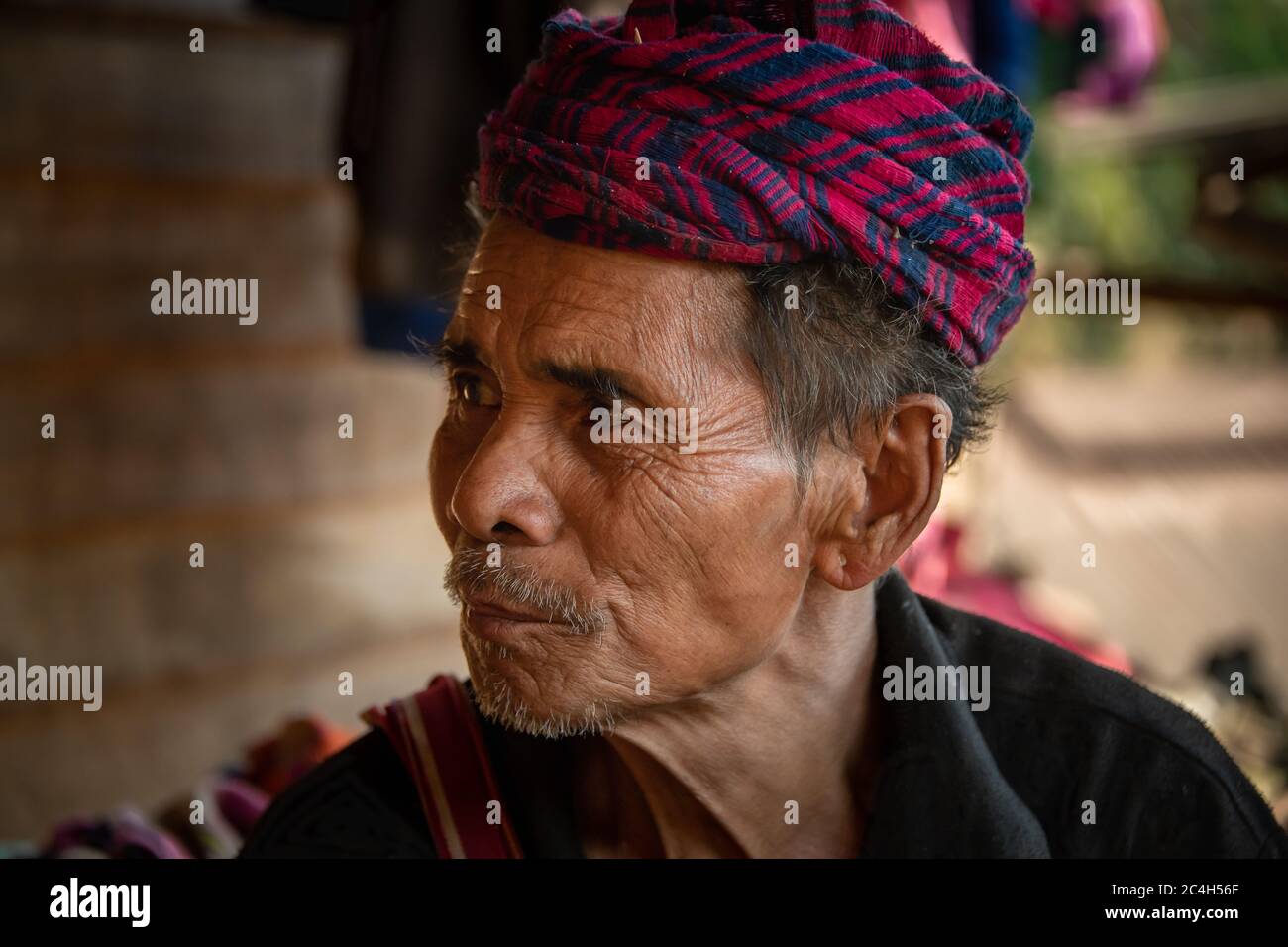 Loikaw, Myanmar - February 2020: Portrait of an old man from the Kayaw Tribe, a minority group living in the remote mountain village of Htay Kho. Stock Photo