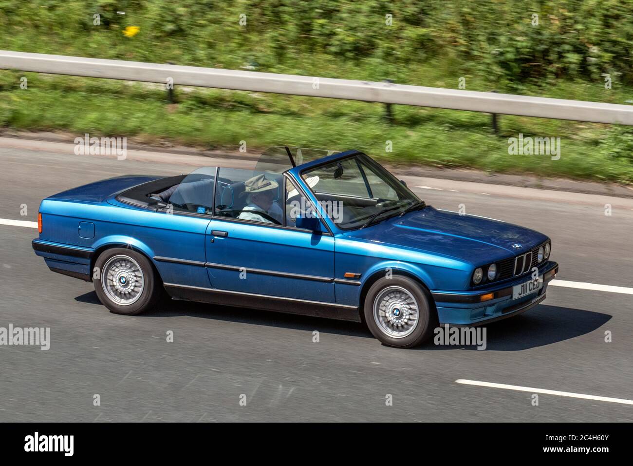 1992 90s blue BMW 318 I Convertible; Vehicular traffic moving vehicles